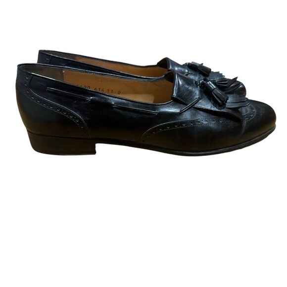 Salvatore Ferragamo black kiltie tassel wingtip loafers